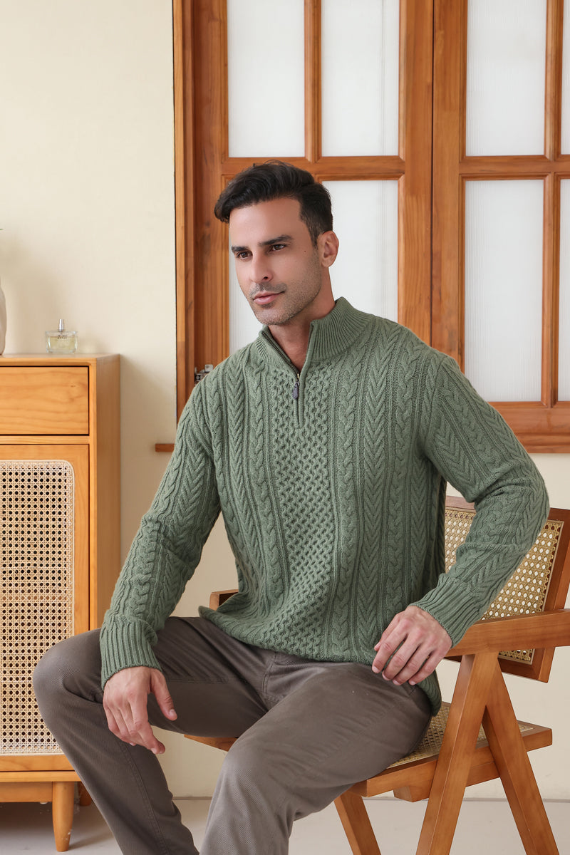 Man wearing a green Aran cable knit sweater by Inis Aran#color_boxwood