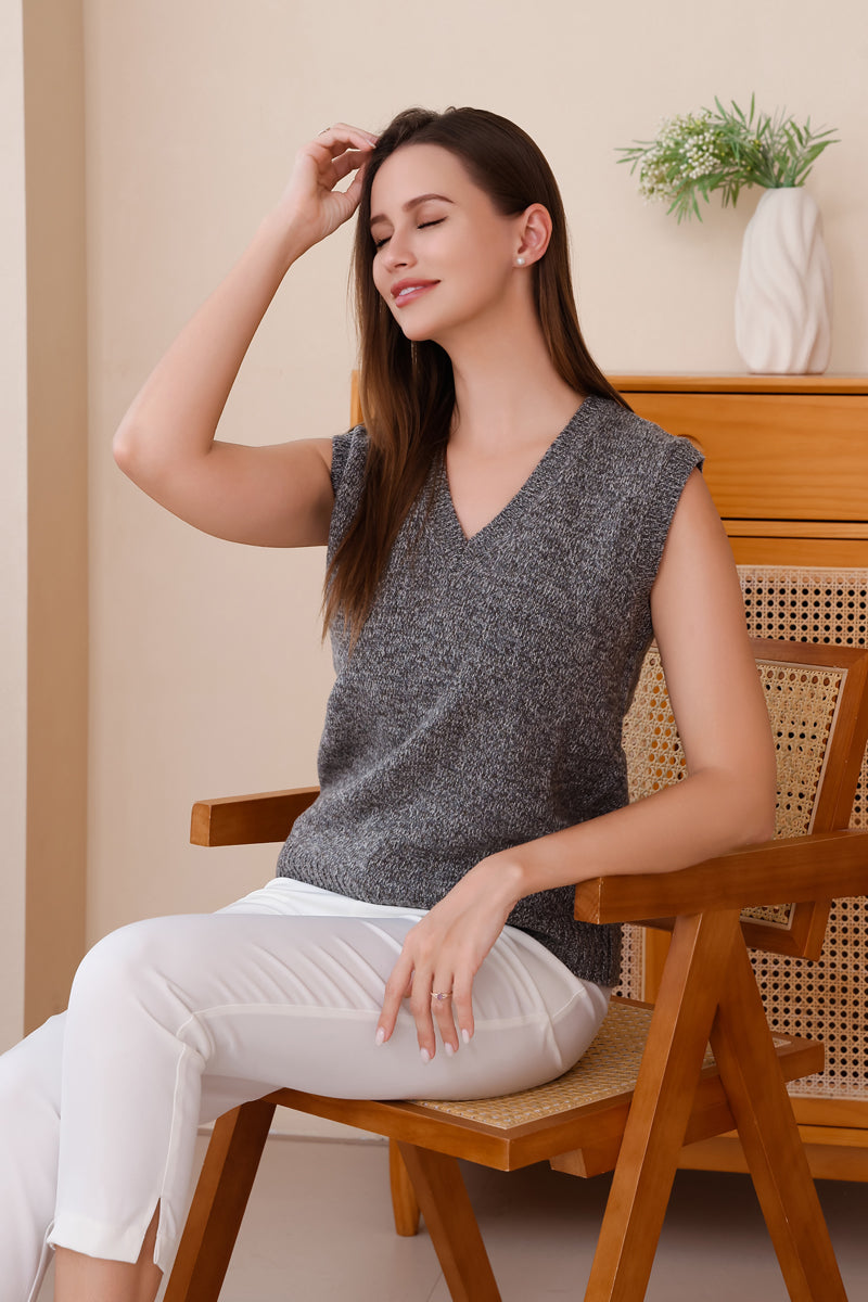 Woman wearing a 100% soft merino wool grey sleeveless vest by Inis Aran Ireland's luxury knitwear brand#color_grey-mix