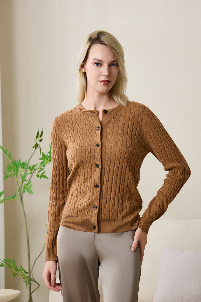 Woman wearing an Inis Aran cashmere medium camel cable cardigan#color_medium-camel