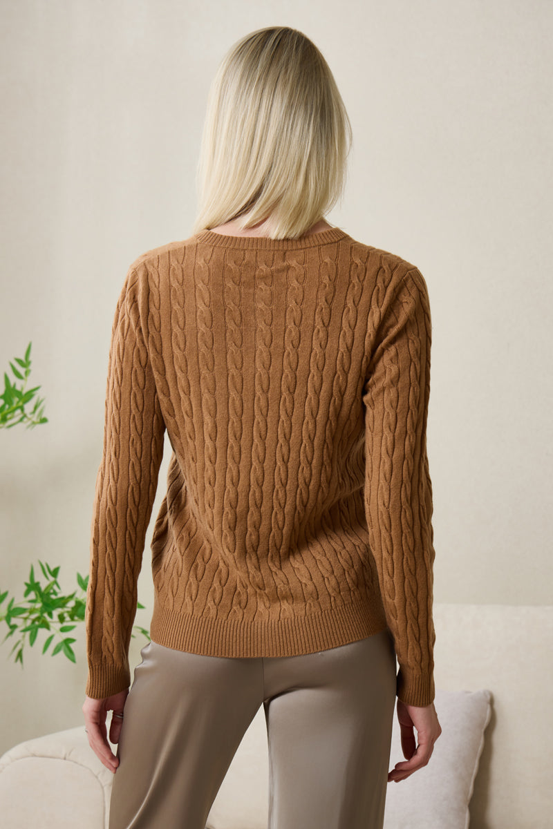 Woman wearing an Inis Aran cashmere medium camel cable cardigan#color_medium-camel