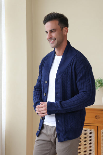 Man wearing the Luca Shawl Neck cable cardigan by Inis Aran#color_bright-navy