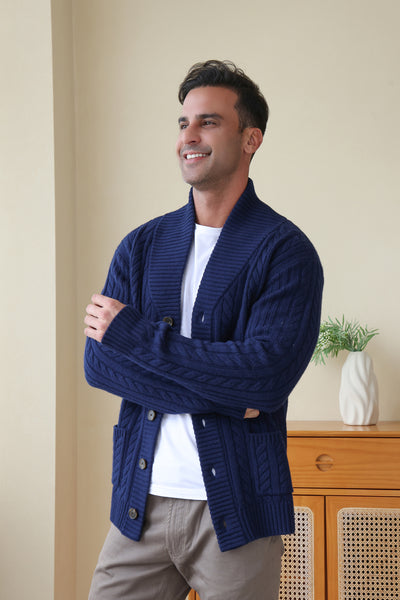 Man wearing the Luca Shawl Neck cable cardigan by Inis Aran#color_bright-navy
