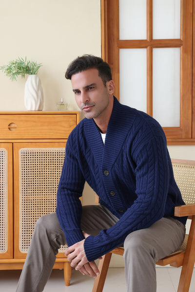 Man wearing the Luca Shawl Neck cable cardigan by Inis Aran#color_bright-navy