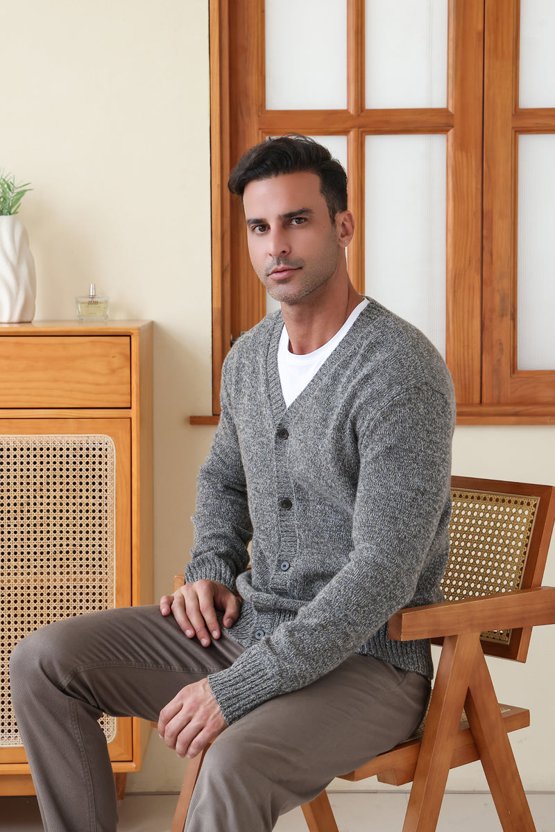 Man wearing the merino twill weave button cardigan by Inis Aran#color_forest-grey