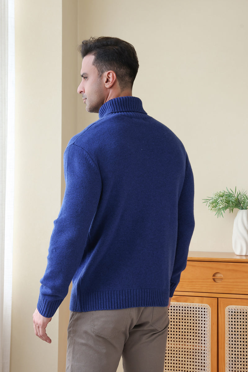 Man wearing a luxurious blue Aran cable knit sweater by Inis Aran Ireland#color_marine
