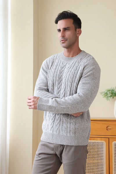 Man wearing a luxurious merino cable knit aran sweater in a twill weave#color_stone