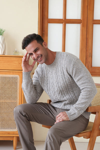 Man wearing a luxurious merino cable knit aran sweater in a twill weave#color_stone