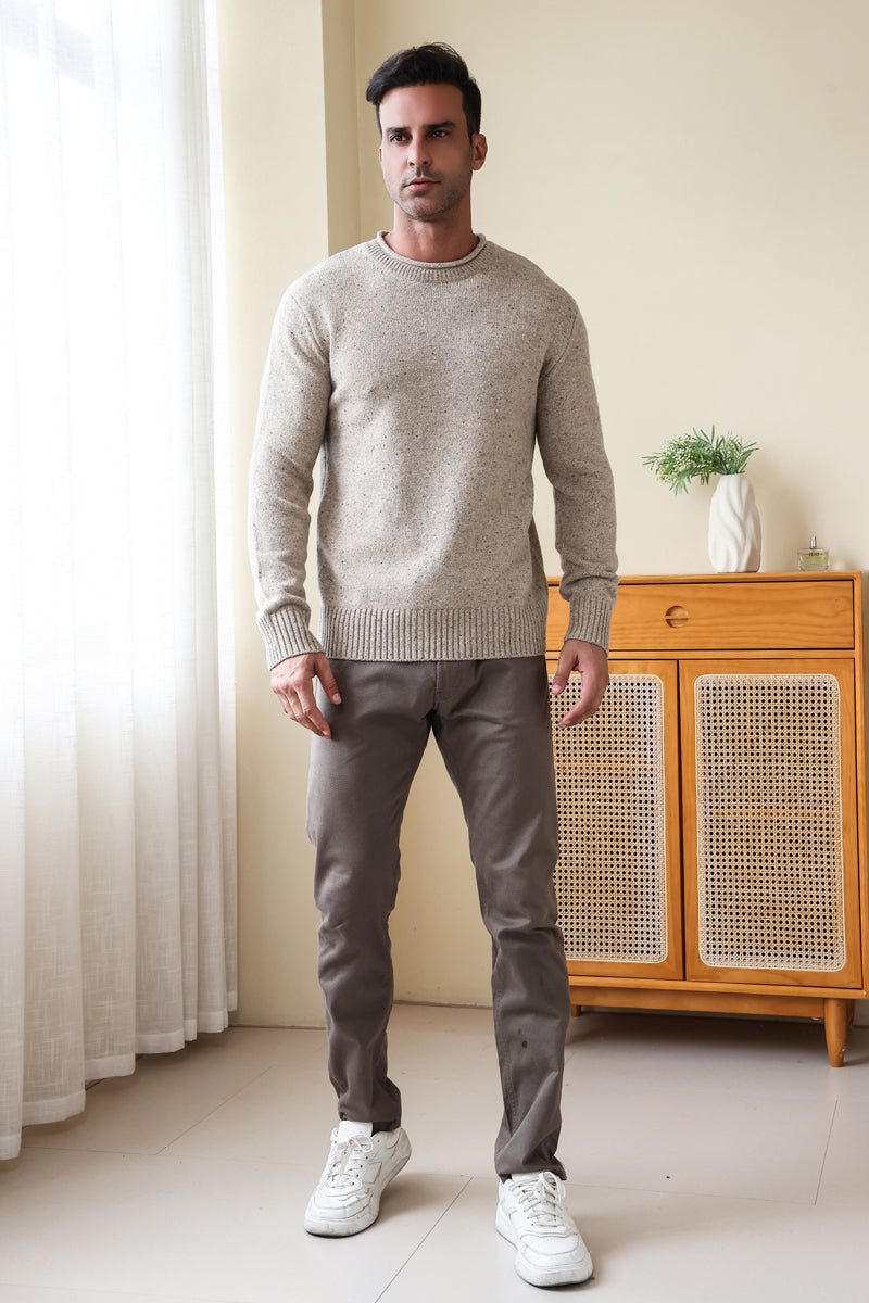 Man wearing the Inis Aran Donegal Merino Roll Neck Sweater#color_ryewater