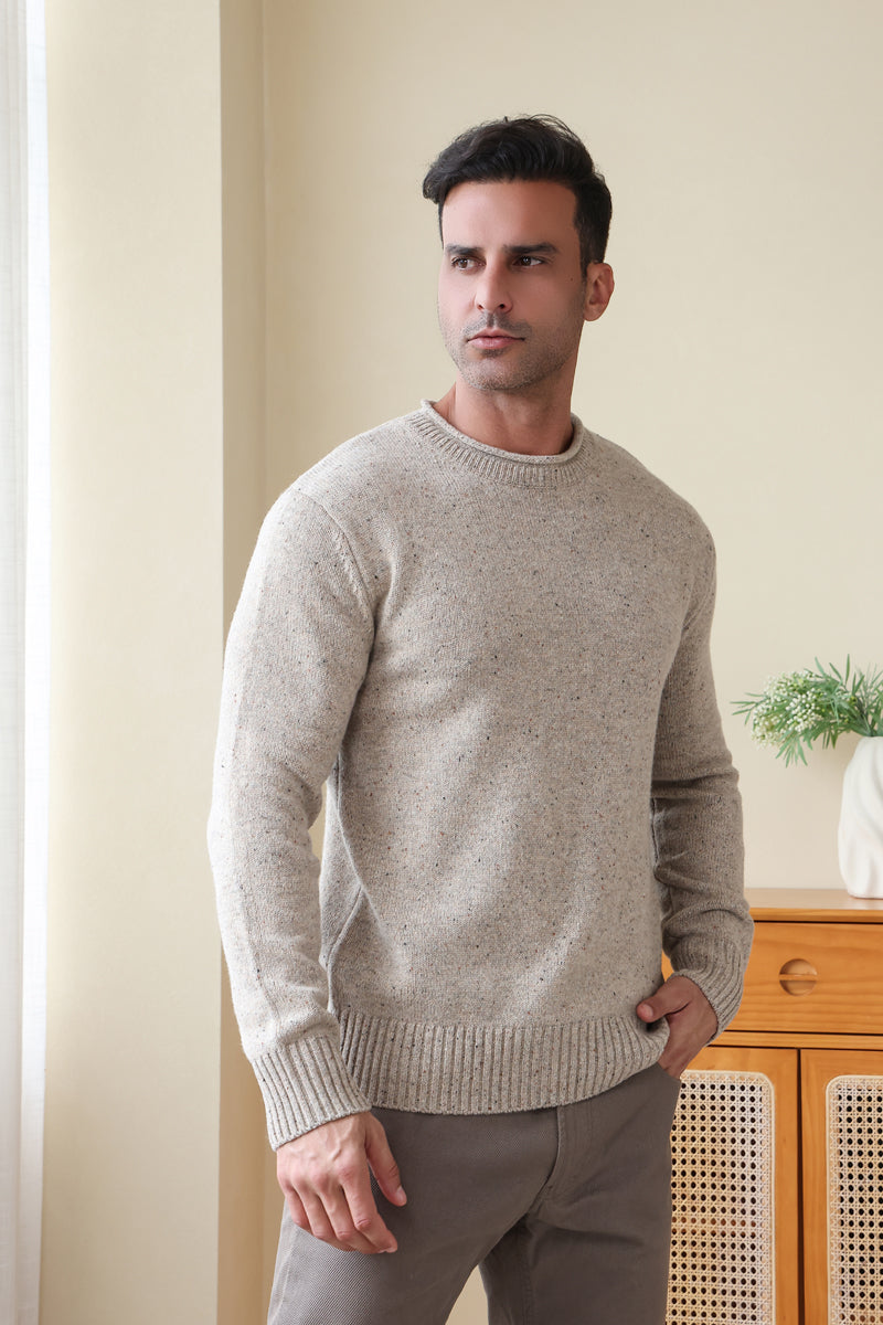 Man wearing the Inis Aran Donegal Merino Roll Neck Sweater#color_ryewater