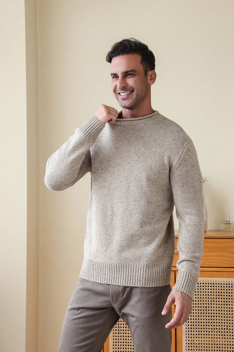 Man wearing the Inis Aran Donegal Merino Roll Neck Sweater#color_ryewater