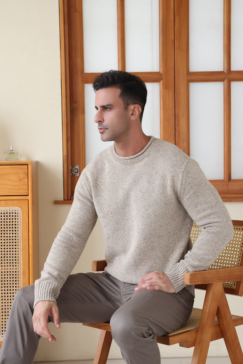 Man wearing the Inis Aran Donegal Merino Roll Neck Sweater#color_ryewater