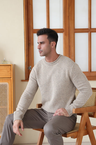 Man wearing the Inis Aran Donegal Merino Roll Neck Sweater#color_ryewater