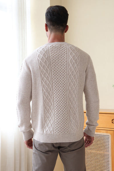 Man wearing a luxury aran cashmere cable knit sweater by Inis Aran Ireland#color_seoul-beige
