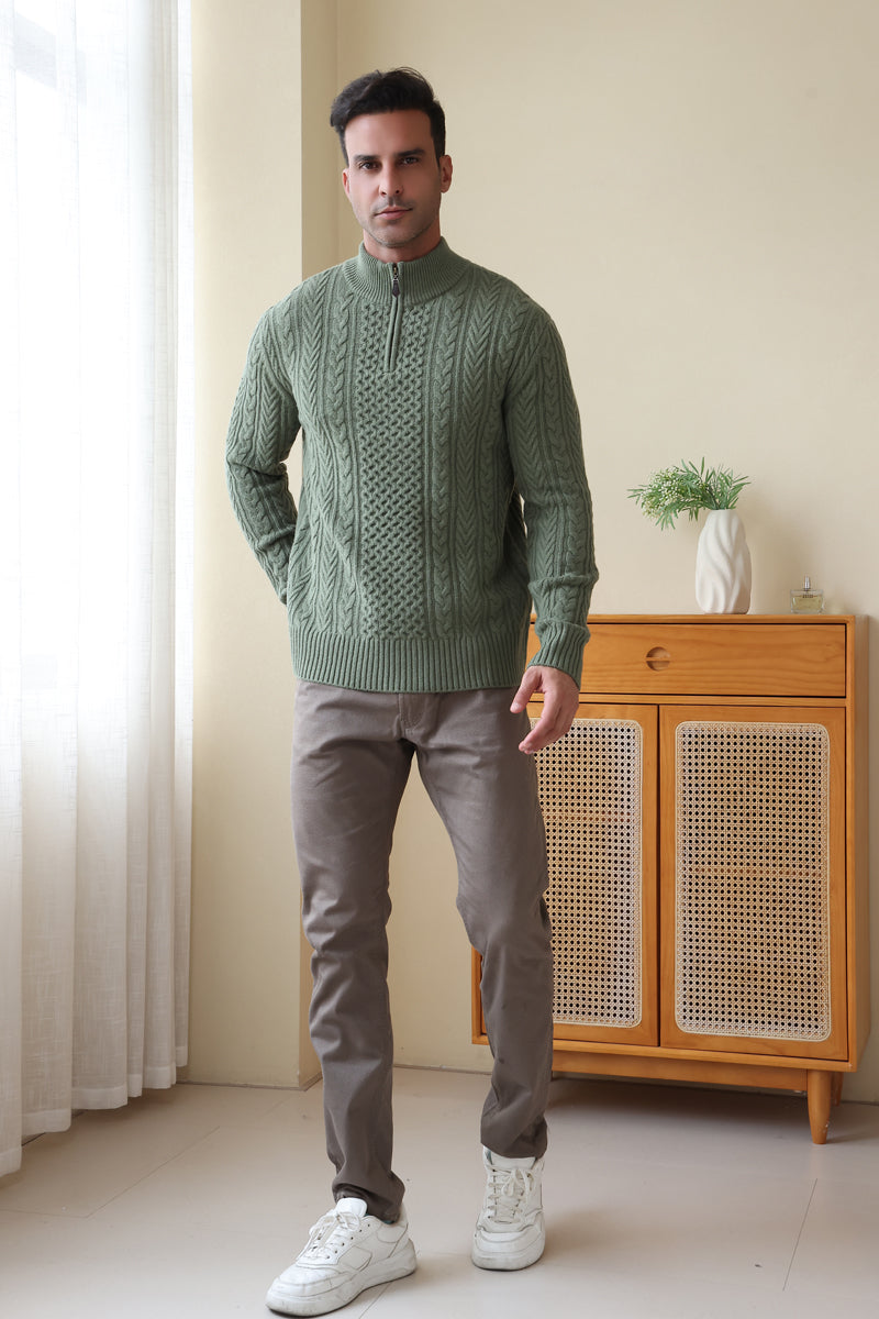 Man wearing a green Aran cable knit sweater by Inis Aran#color_boxwood