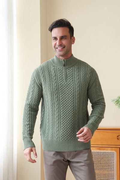 Man wearing a green Aran cable knit sweater by Inis Aran#color_boxwood