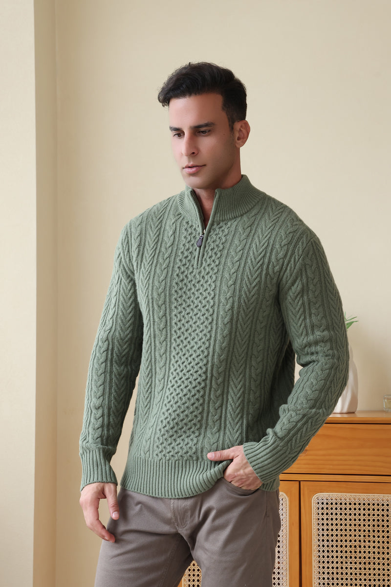 Man wearing a green Aran cable knit sweater by Inis Aran#color_boxwood