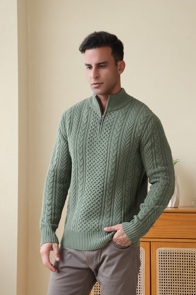 Man wearing a green Aran cable knit sweater by Inis Aran#color_boxwood