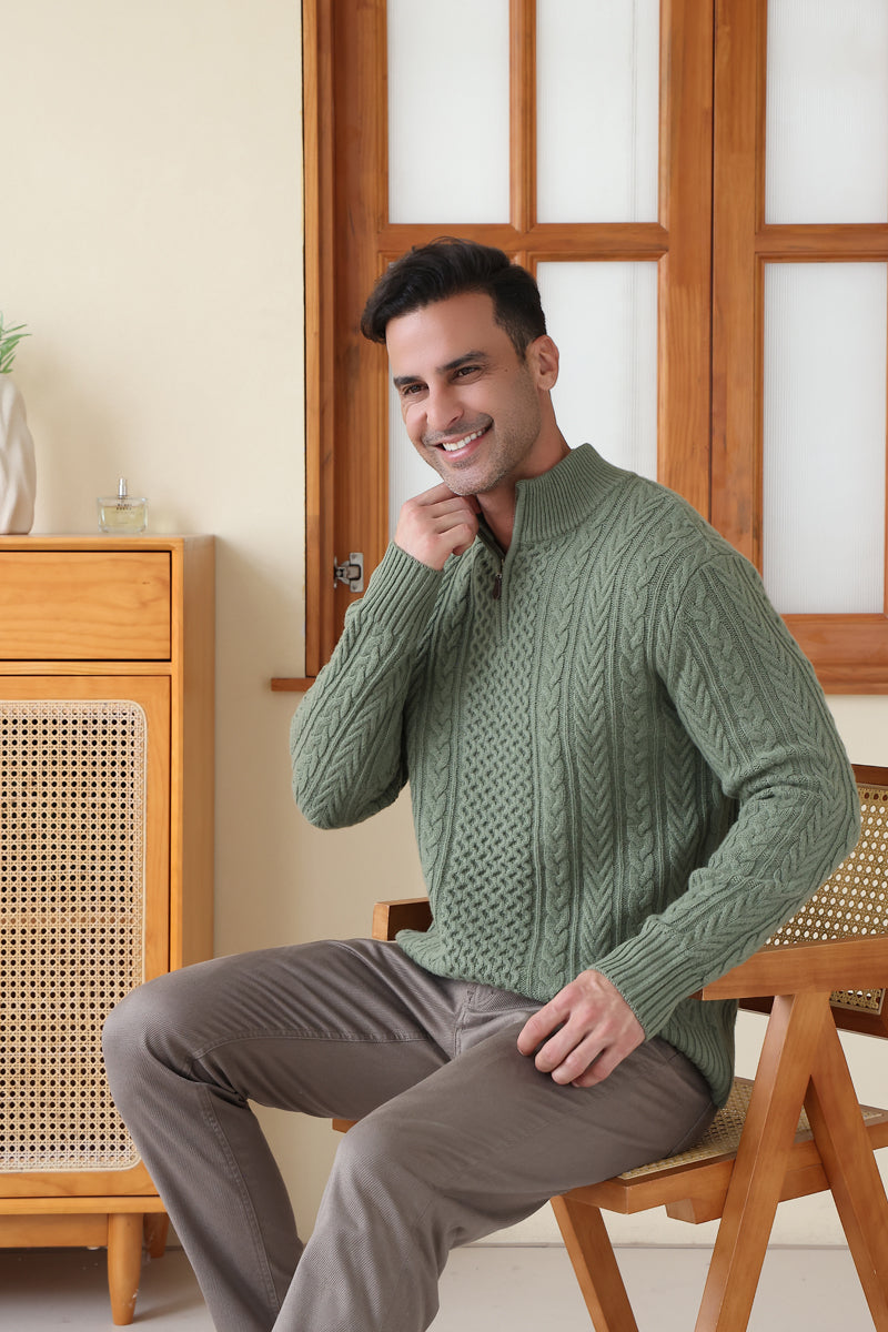 Man wearing a green Aran cable knit sweater by Inis Aran#color_boxwood