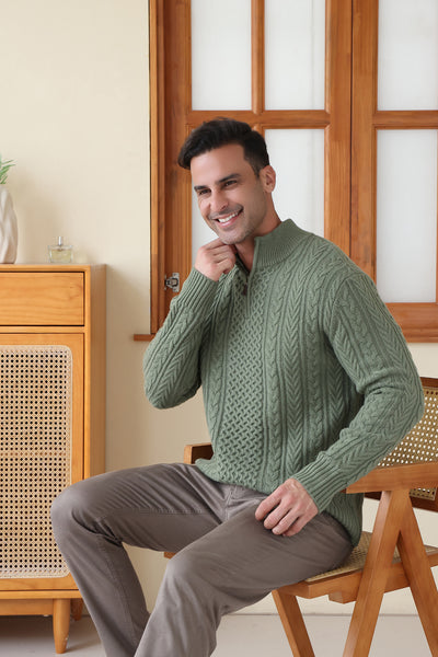 Man wearing a green Aran cable knit sweater by Inis Aran#color_boxwood